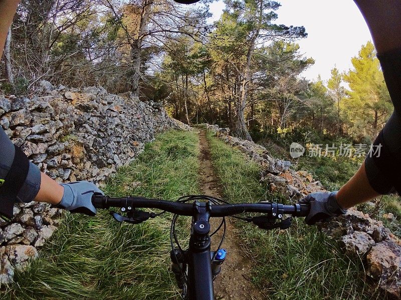 山地自行车女孩骑森林Lošinj /小径地中海夫妇